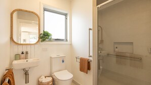 Ein Badezimmer mit Waschbecken, Toilette und einer Duschkabine.