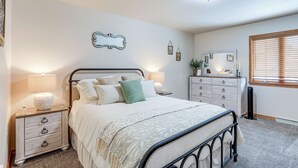 A bedroom with a bed, nightstand, dresser, and a mirror. - Townhome w/ Patio: 1 Mi to Clearfield Riverwalk (Clearfield)
