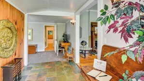 A wooden interior with a tiled floor, a wooden bench, a desk with a laptop, and a wall-mounted light fixture. - 30 Acres & Pond: North Georgia Mtn Farmhouse (Demorest)