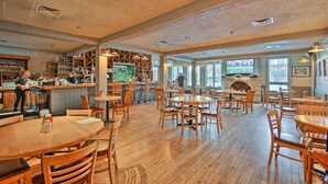 A restaurant with wooden tables and chairs, a bar area, and a fireplace. - 4 MI to Lake Galena: TH w/ Indoor Pool & Views! (Galena)