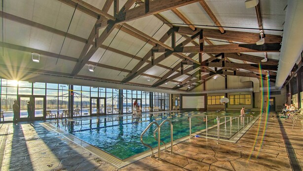 An indoor swimming pool with clear glass walls, a hexagonal tiled floor, and a high wooden ceiling. - 4 MI to Lake Galena: TH w/ Indoor Pool & Views! (Galena)