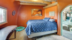 A bedroom with a bed, a window, a desk, and a door leading to a bathroom. - Taos Dome Home w/ Hot Tub, Fireplace + Mntn Views! (Arroyo Hondo)