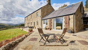 A stone building with a large lawn and outdoor seating area. - Host & Stay | Edge Farm (Lofthouse)