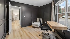A modern room with a desk, chair, and sofa. - The Lofts of Downtown 540 N 2nd St, #207 (Clarksville)