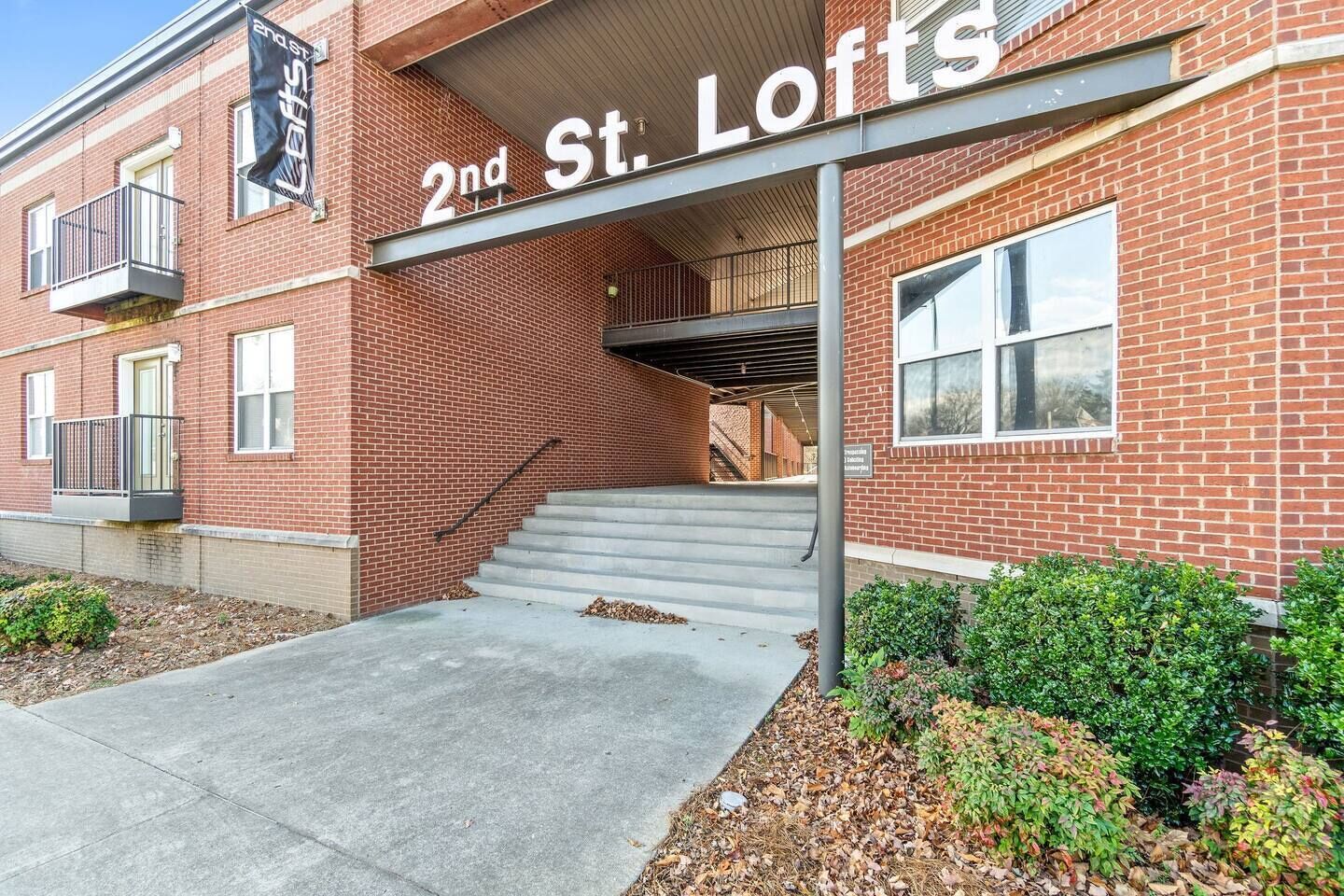 A brick building with a sign reading "2nd St. Lofts".