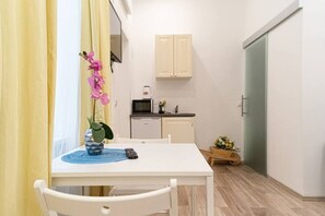 A small, compact kitchen with a microwave, a sink, and a cabinet.