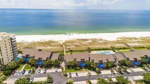 A beachfront hotel with multiple buildings, a swimming pool, and a beach in the background. - NEW Listing!!! Needle Rush Point C26 - Beachfront View - NO HASSLE CHECK OUT (Perdido Key)