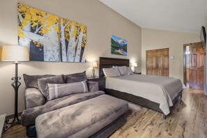 A bedroom with a bed, a sofa, a nightstand, and two wall-mounted lamps. - Fp300 Foxpine Inn 2 Bedroom Condo (Copper Mountain)