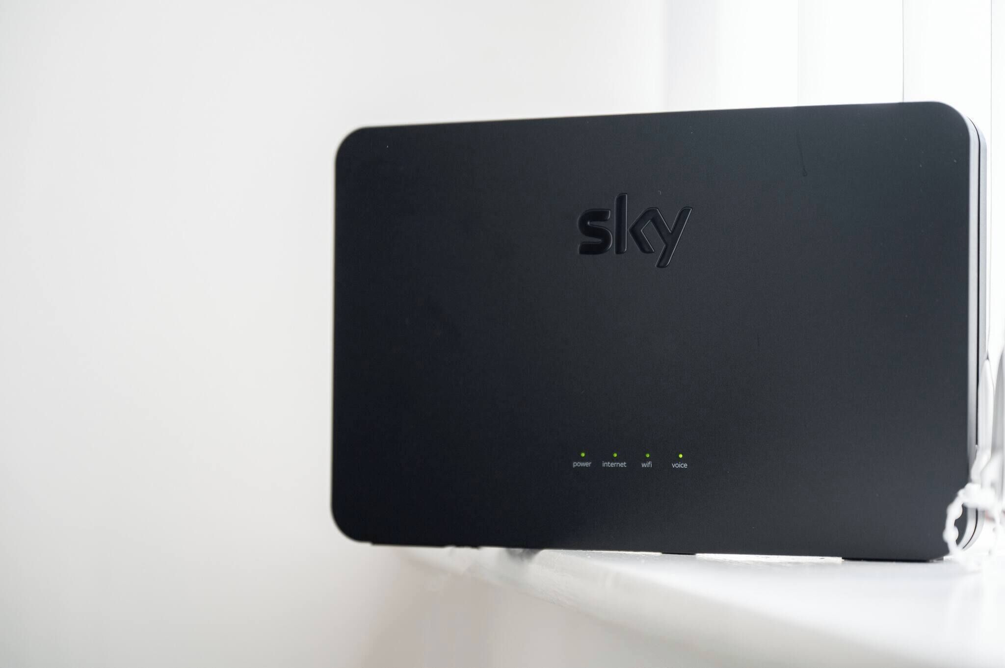 A black electronic device with the brand name 'sky' and four status indicators labeled 'power,' 'internet,' 'wifi,' and 'voice.'