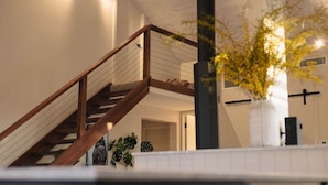 A staircase with wooden railings leading to an upper level.