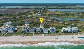 An aerial view of a coastal area with multiple beachfront properties, a beach, and a water body. - Sea Glass Half Full – New Private Pool! (North Topsail Beach)
