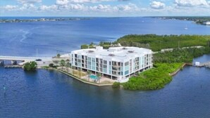 A modern hotel with a white facade, located on a small island surrounded by water. - Sunset Views, Sand Between Your Toes-Your Winter Escape Awaits! (Englewood)