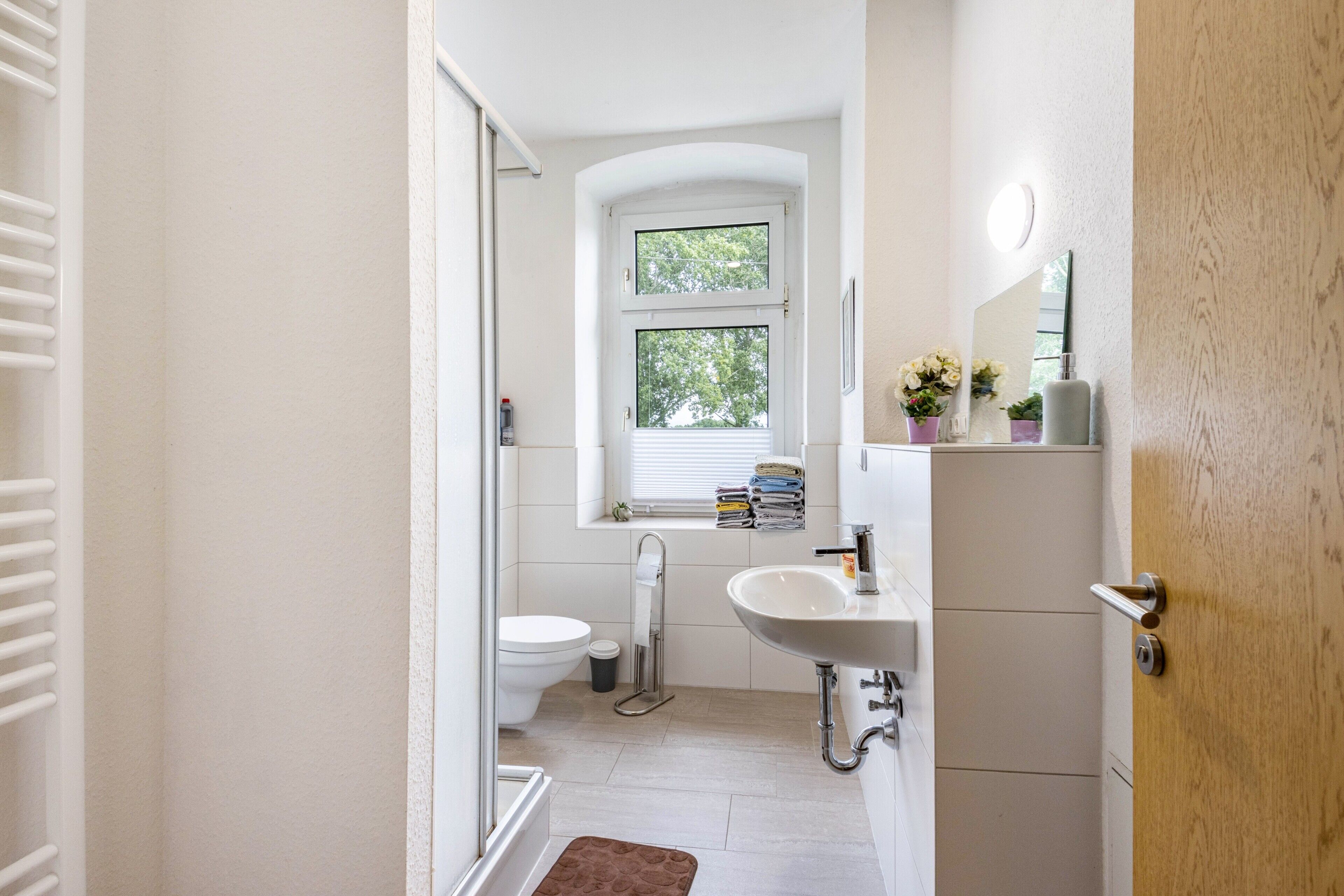 Ein Badezimmer mit Toilette, Waschbecken und Fenster.
