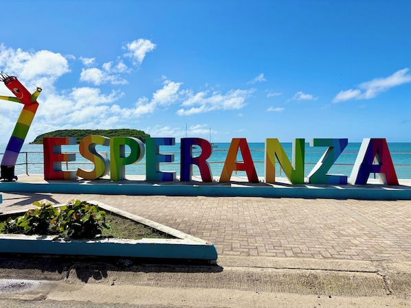 A colorful sign spelling "ESPERANZA" with a rainbow-colored pole to the left. - Best Location in Vieques! Studio/Steps to Ocean, Biobay, Restaurants and Beaches (Esperanza)