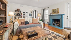 A cozy living room with a sofa, a fireplace, and a bookshelf. - 2 Bedroom in Emerywood, High Point, NC (High Point)