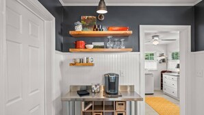 A kitchen with white cabinetry, a coffee maker on the counter, and a yellow rug. - 2 Bedroom in Emerywood, High Point, NC (High Point)