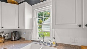 A kitchen with white cabinetry, a granite countertop, a built-in oven, and a window with a view of greenery. - 2 Bedroom in Emerywood, High Point, NC (High Point)