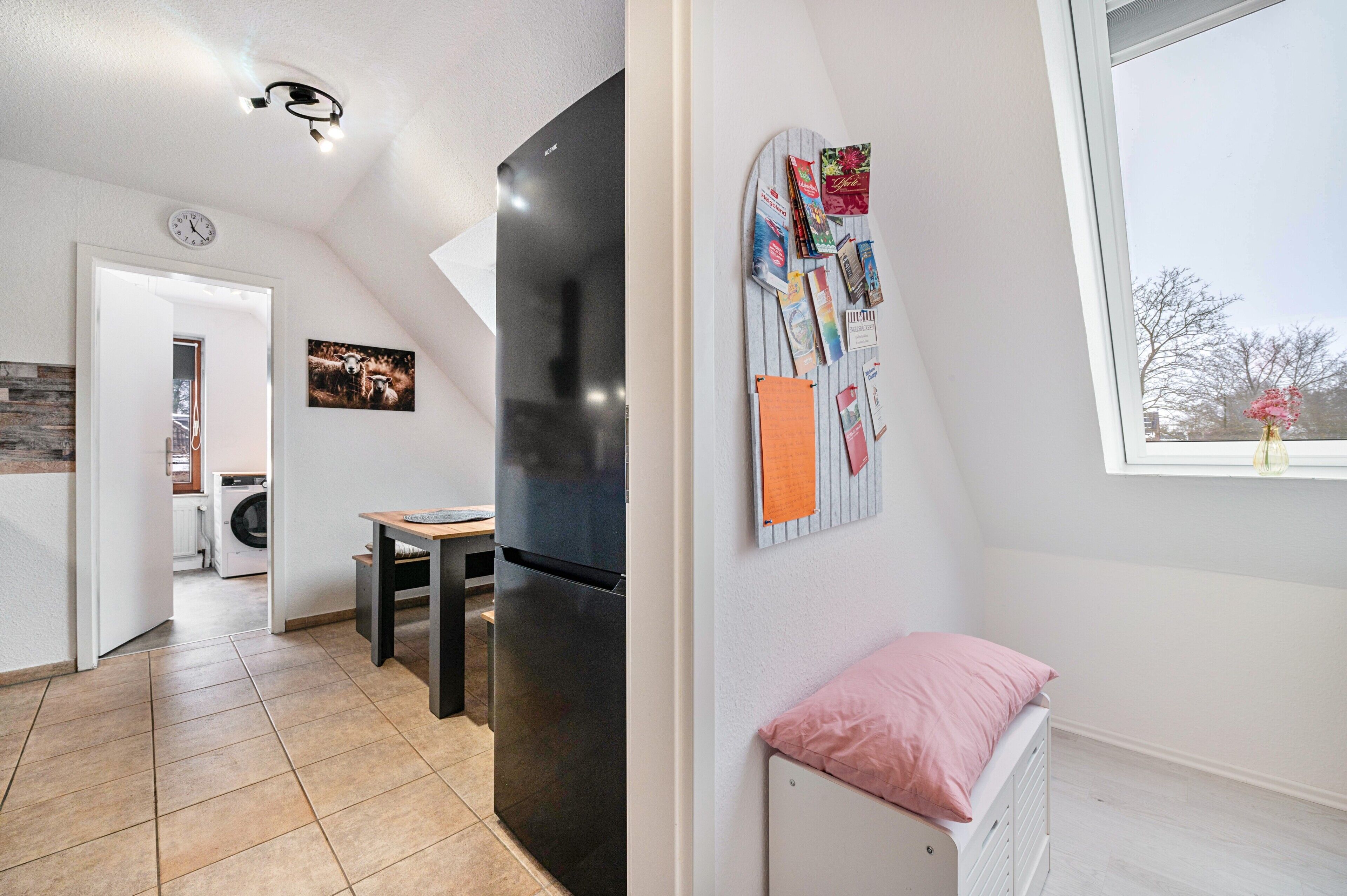 A modern interior with a kitchen, dining area, and a child's room with a window view.