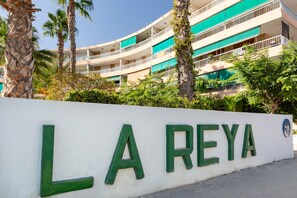 A multi-story building with balconies and a sign that reads 'LA REYA'.