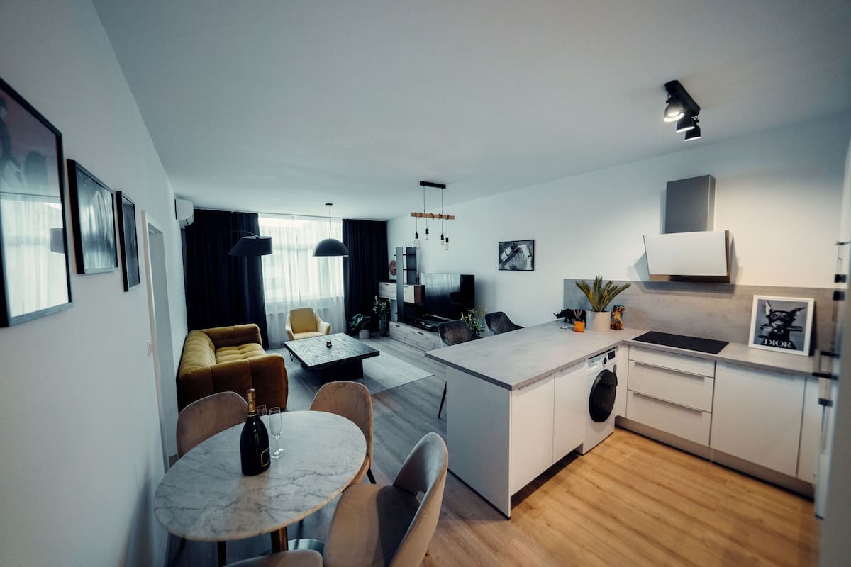 Un appartement moderne comprenant un coin repas, une cuisine et un espace de vie.