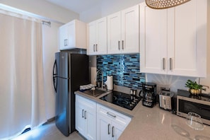 Fridge, microwave, stovetop, coffee/tea maker