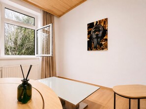 A room with a table, a chair, a window with curtains, and a wall-mounted artwork. - Pack Your Plans Vienna Room for Two with Desk near FAC Platz (Vienna)