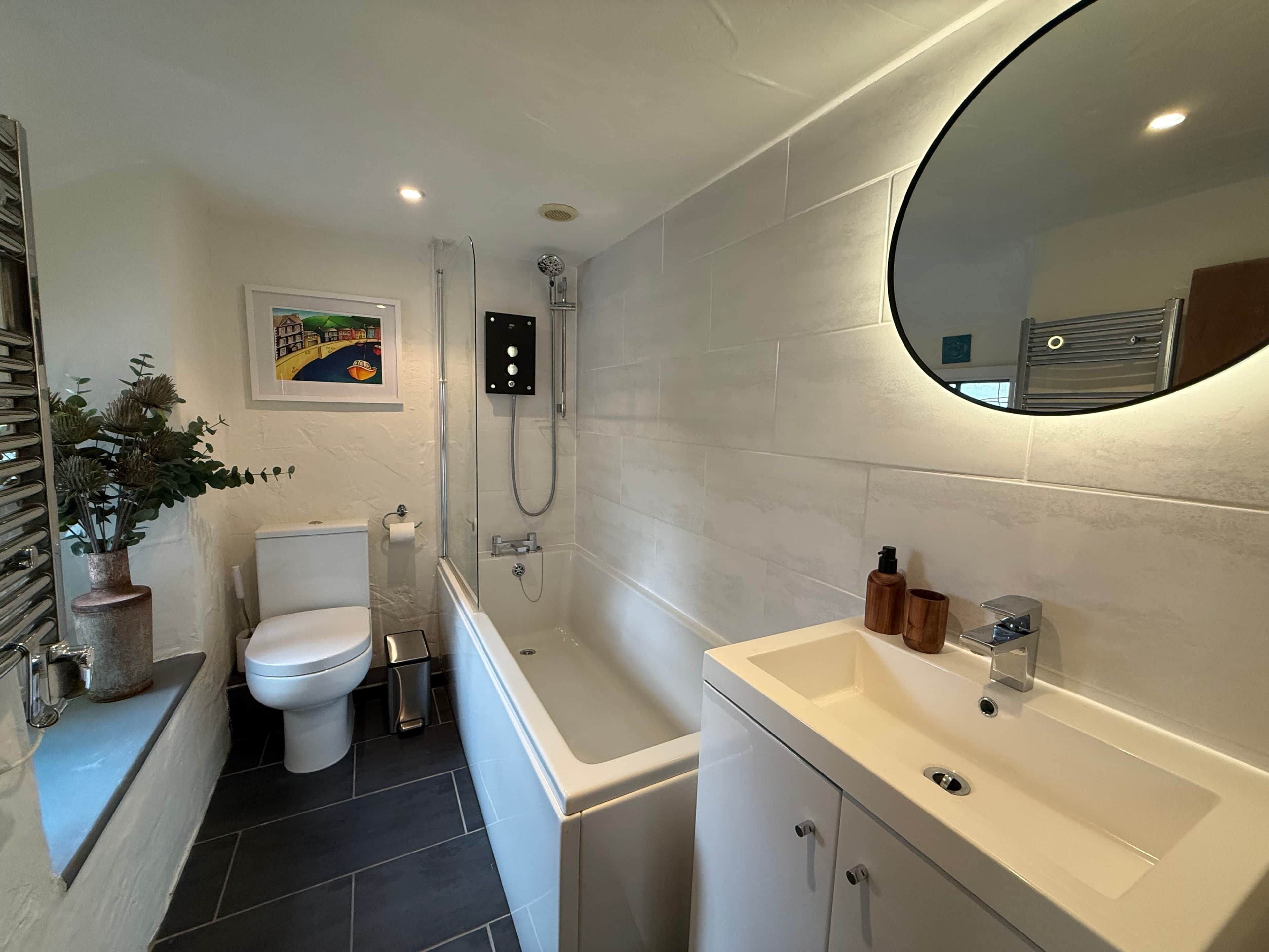 Une salle de bain moderne équipée de toilettes, d’une douche et d’un lavabo.