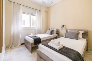 Appartamento, 2 camere da letto, cucina, vista città | Una scrivania, postazione laptop, tende oscuranti, ferro/asse da stiro