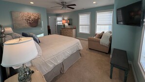 A bedroom with a bed, a dresser, a chair, a TV, and a ceiling fan. - NEW KI Creek Retreat! 3BR/2bath water view, private house near KI wedding venues (Stevensville)