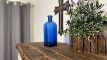 A wooden table with a blue vase and a plant.