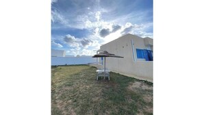 A building with a flat roof and a single-story structure. - A villa on the waterfront (Kerkouane)