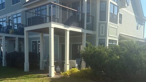 A two-story house with a covered porch, a lawn, and a large bush. - Beautiful 3 Bedroom condo apt near Owl's Nest golf course and wedding venue (Thornton)
