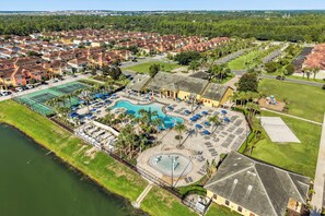 A residential area with a swimming pool, tennis courts, and a playground.