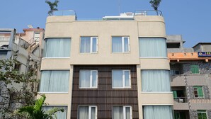 A multi-story building with a flat facade, large windows, and a central entrance.