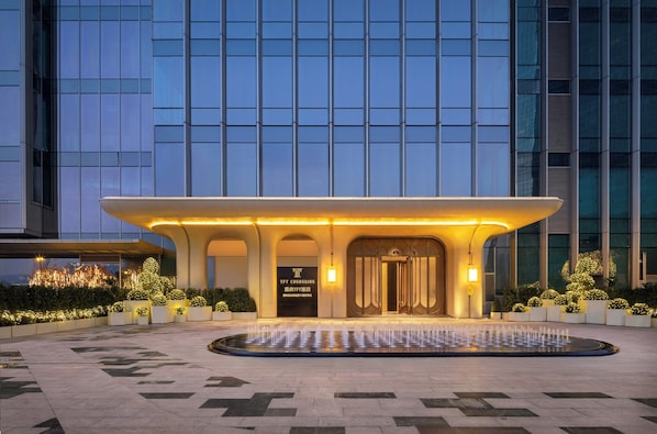 A hotel entrance with a fountain, modern architecture, and well-lit surroundings. - TFT Chongqing, Vignette Collection by IHG (Chongqing)