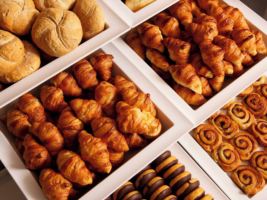 A variety of baked goods including croissants and cinnamon rolls.
