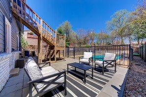 A patio with outdoor furniture, a pool, and a wooden deck. - Charming studio with pool near downtown Tulsa (Tulsa)