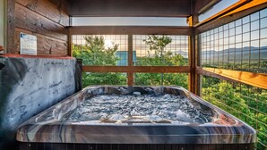 A hot tub with a wooden interior and a view of mountains through a wire mesh window. - Rustic 3bed Cabin w/ Perfect Views of The Smokies! (Gatlinburg)