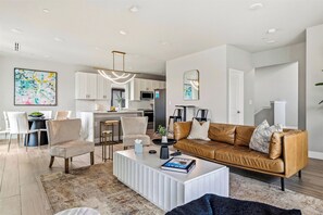 Start the evening on the couch and end it at the dining table. It all shares one open floor, so the cook stays in the conversation.