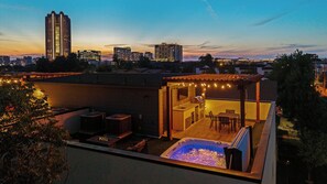 Watch the sun go down over the Dallas skyline from your own hot tub. By dusk the string lights come on and the roof is all yours.