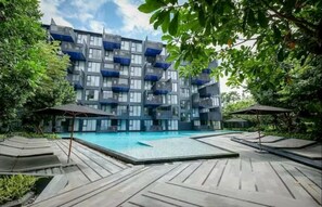 A modern building with balconies and a swimming pool. - The Deck Patong Phuket by Mickey (Patong)