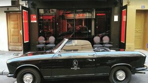 A black convertible car parked in front of a building with a sign that reads "HOTEL" and a number "62" on the wall. - Confidential Room 1, a Stone's Throw From the Louvre (Paris)