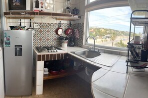 Fridge, microwave, stovetop, coffee/tea maker