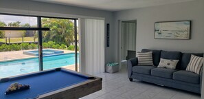 Game room - Cozy, bright, and spaciuos WF home with pool, dock, pool table & more. (Cape Coral)