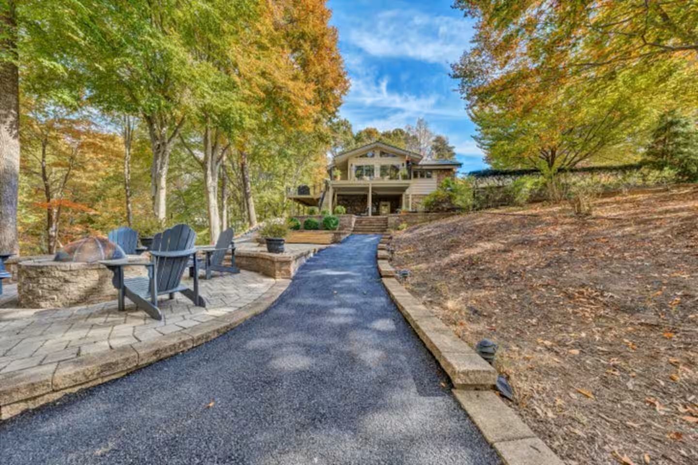 Firepit and side view of the house with paved walkway