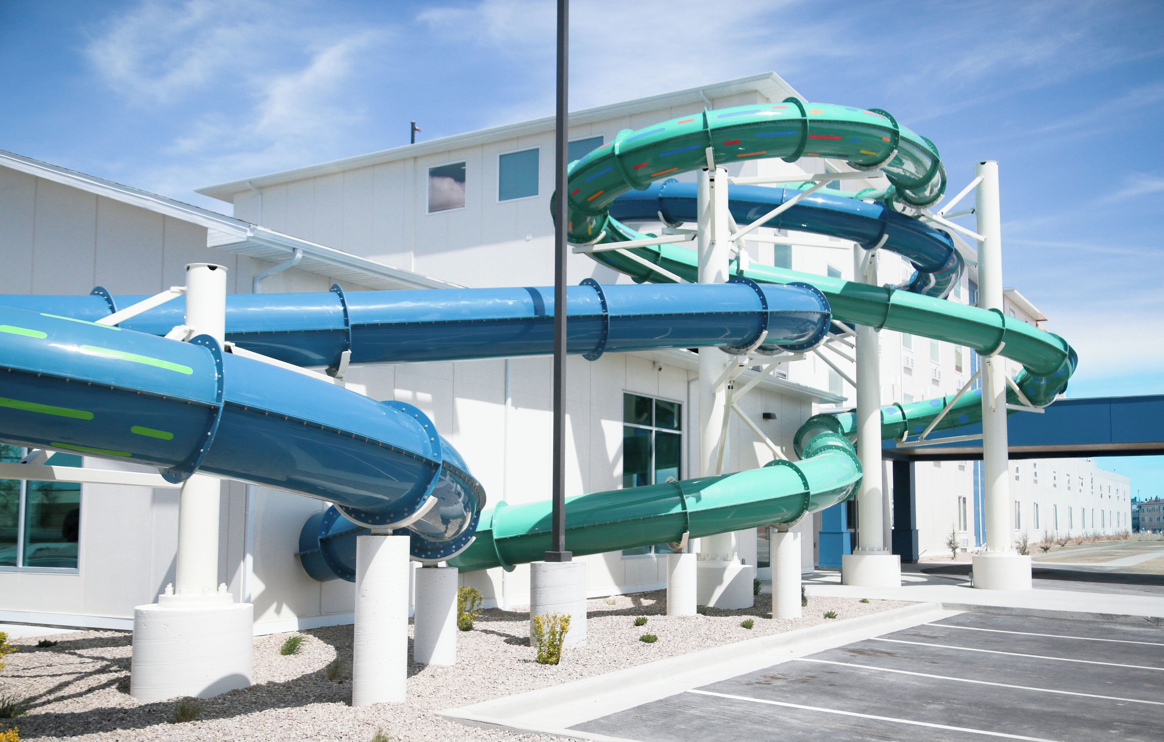 A water park with multiple slides and a building in the background.