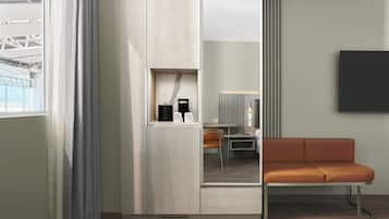 A modern room with a wooden cabinet, a sofa, and a mirror.