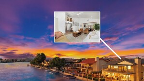 A waterfront property with a spacious living area, a balcony, and a view of the water. - Lakeside Retreat Hot Tub, Fire Pit, 4BR/3BA (Victorville)