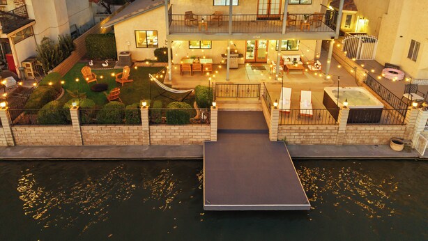 A two-story house with a patio, outdoor seating, and a dock over water. - Lakeside Retreat Hot Tub, Fire Pit, 4BR/3BA (Victorville)