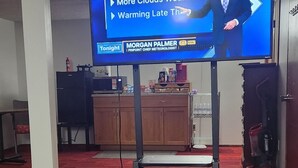 A television displaying a weather forecast.